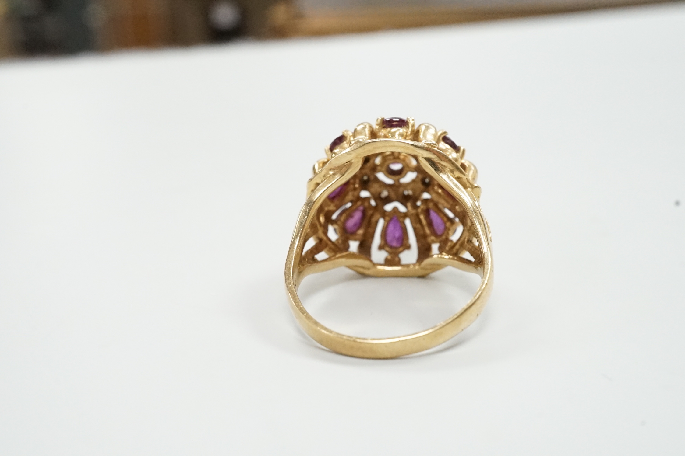 A modern 14ct gold, amethyst? and diamond chip cluster set domed dress ring, size M, gross weight 7.2 grams.